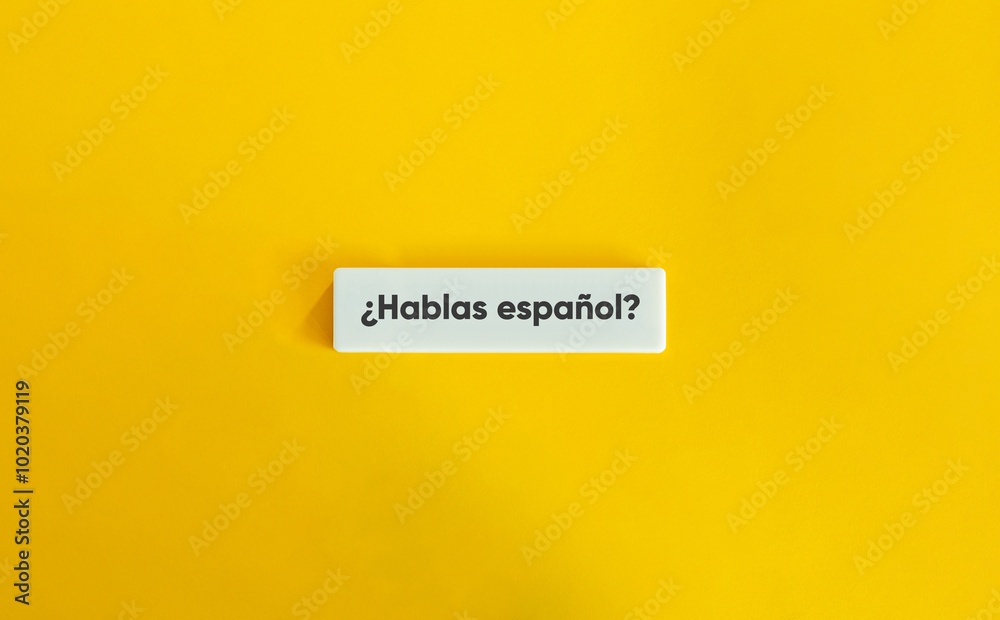 ¿Hablas español? Text on Block Letter Tile on Yellow Background. Minimal Aesthetic. ¿Hablas español? Text on Block Letter Tile on Yellow Background. Minimal Aesthetic.