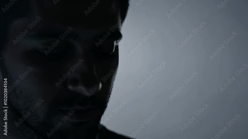 Shadowed portrait of pensive man in soft light Shadowed portrait of pensive man in soft light