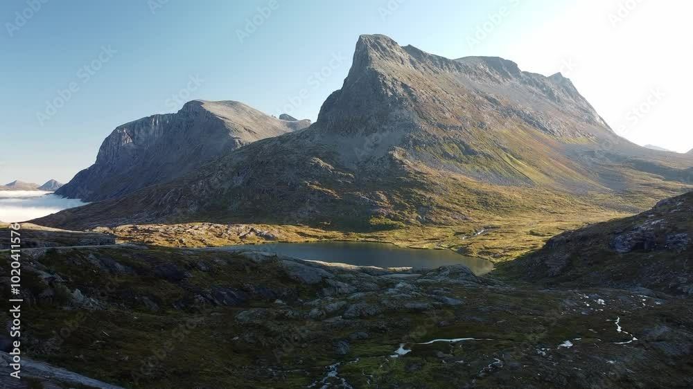 Beautiful mountain behind a lake during sunset in Norway. Beautiful mountain behind a lake during sunset in Norway.