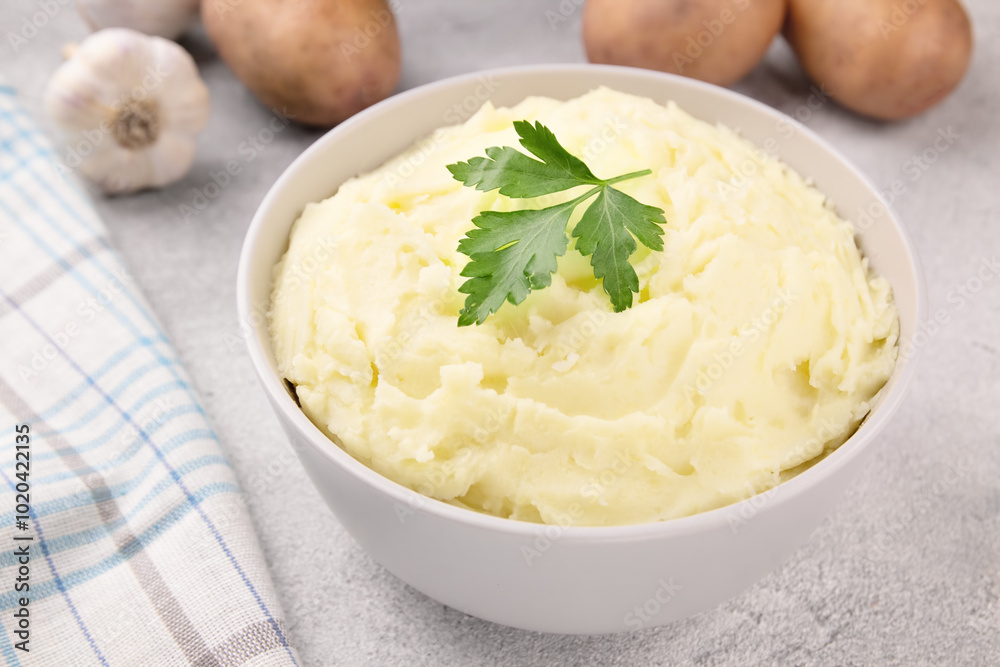 Mashed potatoes in white bowl on grey concrete background. Healthy food Mashed potatoes in white bowl on grey concrete background. Healthy food