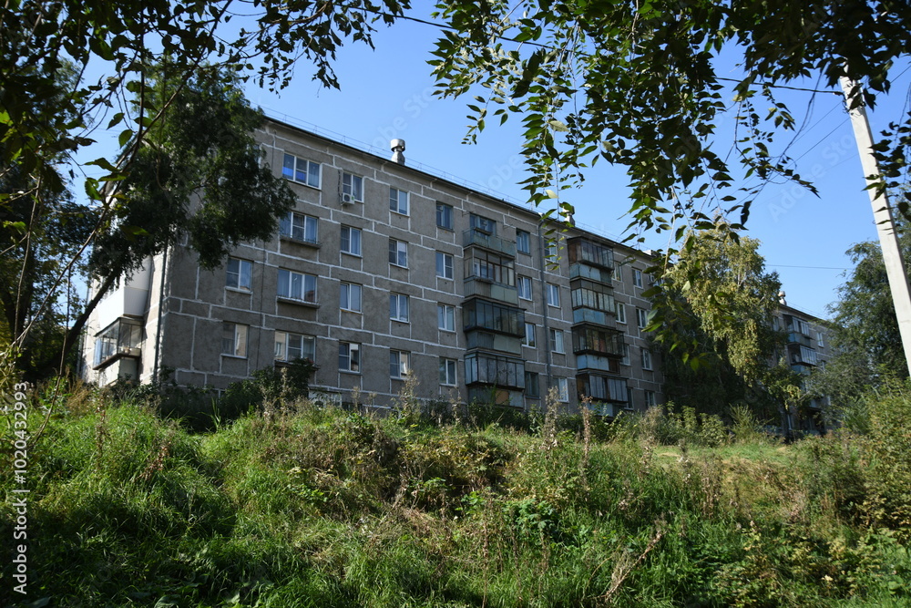 Cityscape of Russia. Panel house of the Soviet Union, old architecture of the building in the brutalism style Cityscape of Russia. Panel house of the Soviet Union, old architecture of the building in the brutalism style