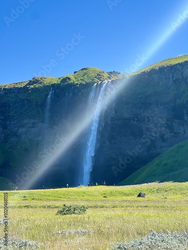 Skógafoss invites you to marvel at its towering heights, a serene yet powerful waterfall that captivates the soul. photo