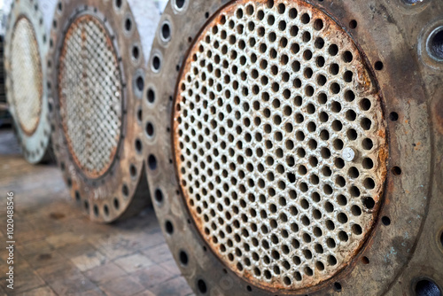 Corrosion, refinery heat exchanger chiller tubes with flange system. Two Industrial heat exchangers or boiler rusty tube sheet or tube board with deposits and corrosion at petrochemical enterprise
