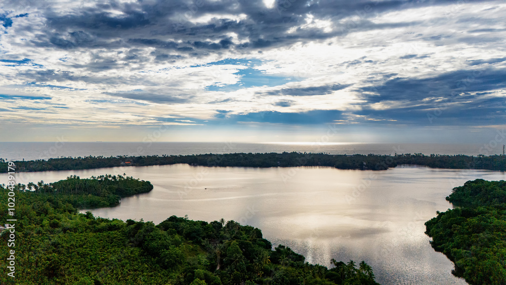 Majestic lake view in Sri Lanka during sunset. A tranquil lake reflects the colorful sky as the sun sets, surrounded by lush greenery and palm trees in Sri Lanka's serene landscape. Majestic lake view in Sri Lanka during sunset. A tranquil lake reflects the colorful sky as the sun sets, surrounded by lush greenery and palm trees in Sri Lanka's serene landscape.
