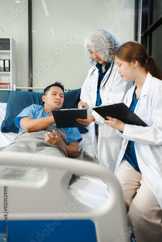 Doctor talking with man patient for monitoring and check up after surgery. doctor touching patient hand and consoling.