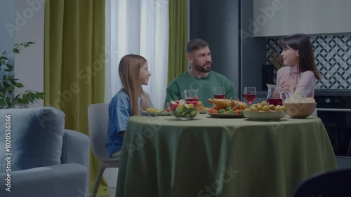 Family dinner, parents and children socializing . Cozy time with Family. Family evening. Thanksgiving. A beautiful caucasian family at dinner. 