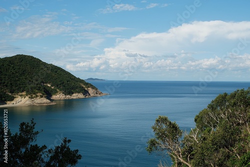 Tranquil coastal view with rolling hills and serene blue waters on a sunny day