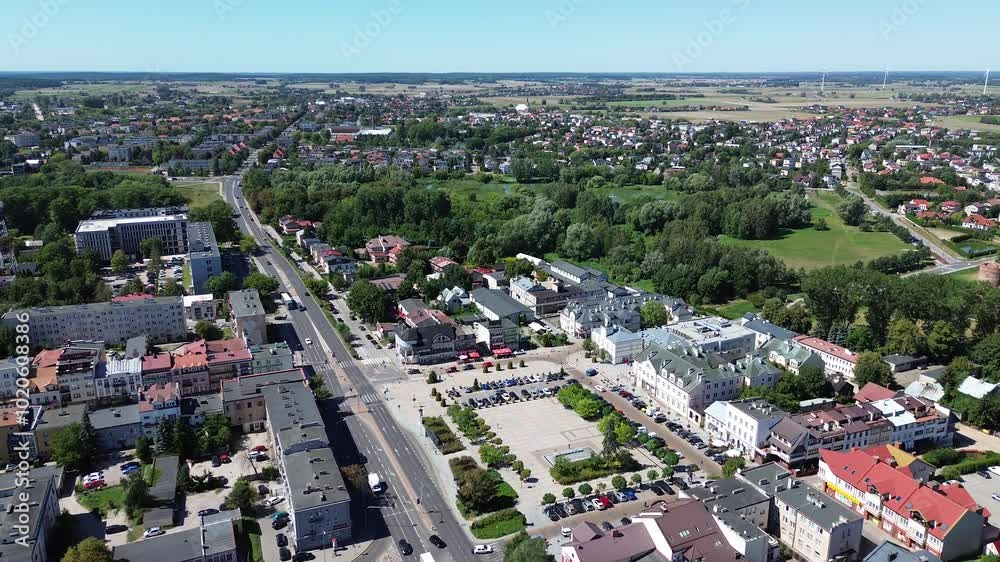 Panoramic aerial view of John Paul II Square, Ciechanow, Poland, with cityscape on the horizon. Dolly in drone flight Panoramic aerial view of John Paul II Square, Ciechanow, Poland, with cityscape on the horizon. Dolly in drone flight