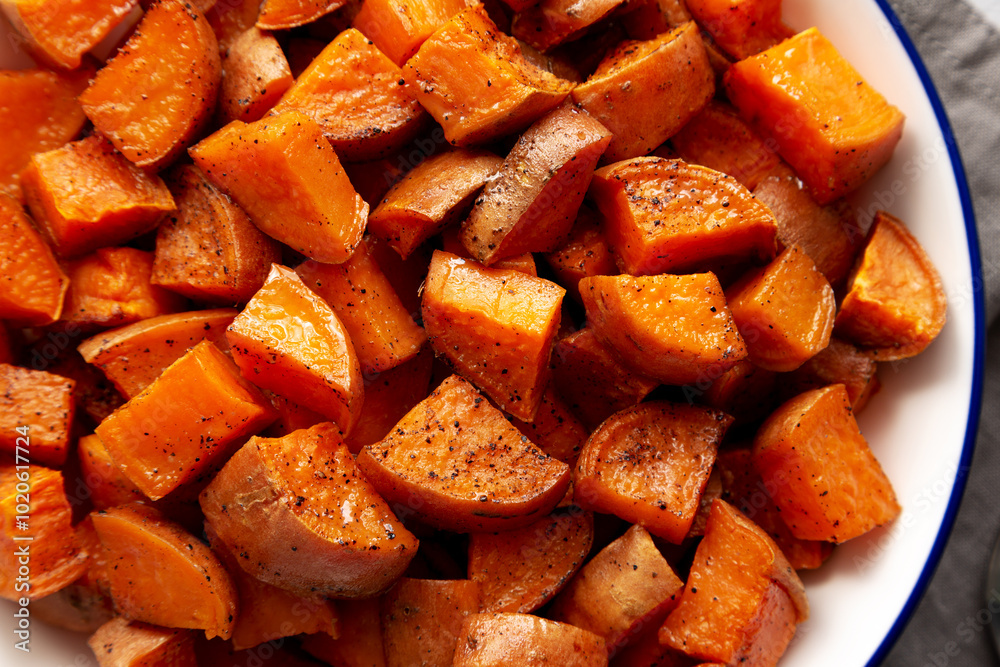 Homemade Roasted Sweet Potatoes on a Plate, top view. Homemade Roasted Sweet Potatoes on a Plate, top view.