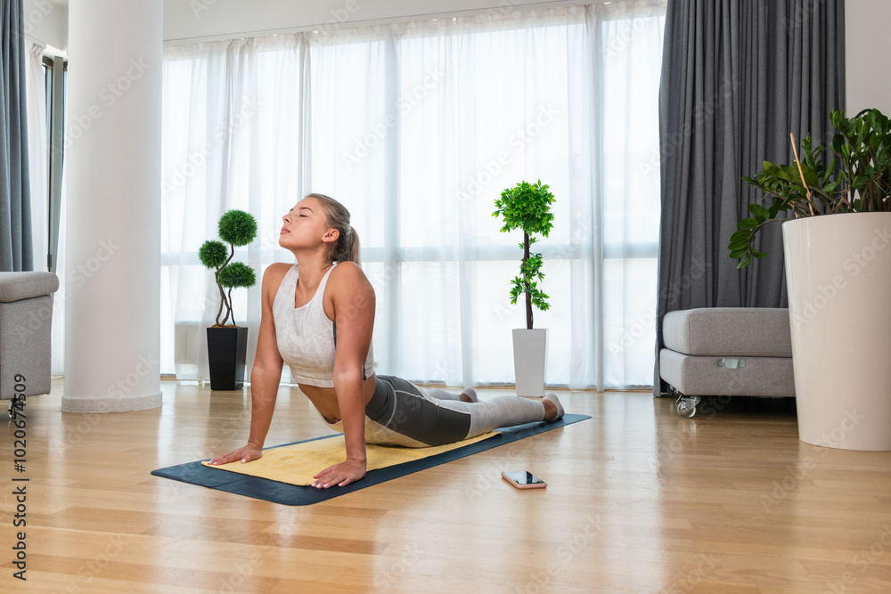 Home workout. Young healthy happy self aware confident woman practicing sport training at home in her apartment, stretching muscles and breeding exercise for better life and success. Home workout. Young healthy happy self aware confident woman practicing sport training at home in her apartment, stretching muscles and breeding exercise for better life and success.