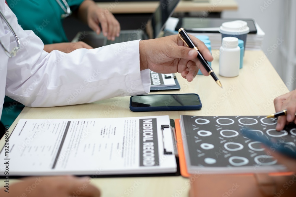 Fototapeta premium Businessman shaking hands with doctor in conference room Doctor and pharmacist shaking hands in medical office Salesman with new medicines shaking hands in hospital with medical team
