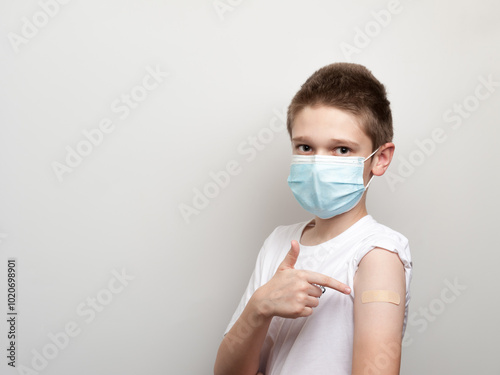 An adhesive plaster for the injection site protection glued on the hand of young boy