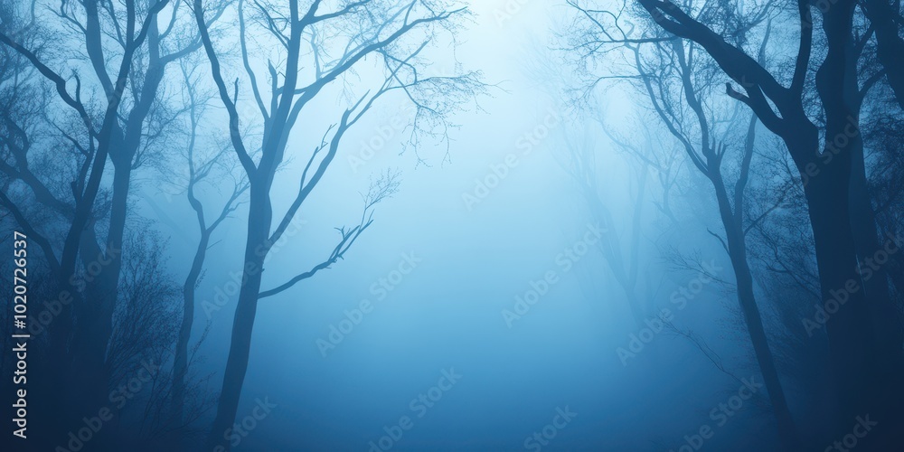 Mystical forest shrouded in dense fog, creating an ethereal and serene atmosphere with bare trees and soft blue tones. Mystical forest shrouded in dense fog, creating an ethereal and serene atmosphere with bare trees and soft blue tones.