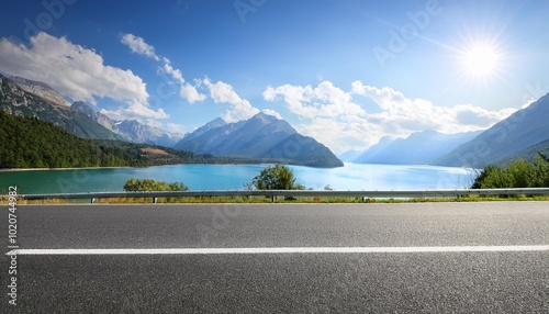 asphalt highway road and lake with mountains nature landscape on a sunny day beautiful coastline in summer season