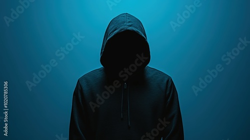 Mysterious hooded figure in the dark