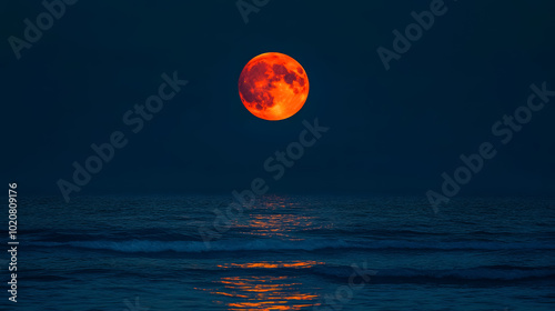 Full Red Moon Over Sea: The full red moon reflecting over the sea.