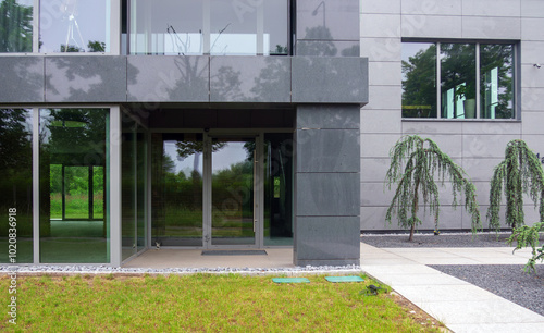 Modern glass office building and lawn