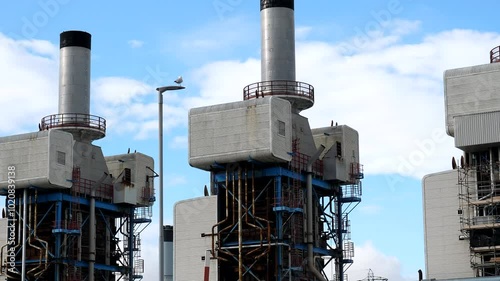 Tilt up shot showing 3 waste heat recovery boilers of Fellside Heat and Power Plant at Sellafield nuclear power station site.