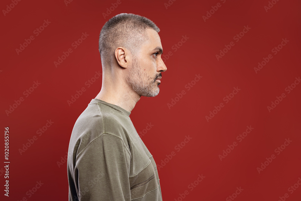 serious man in profile looking forward