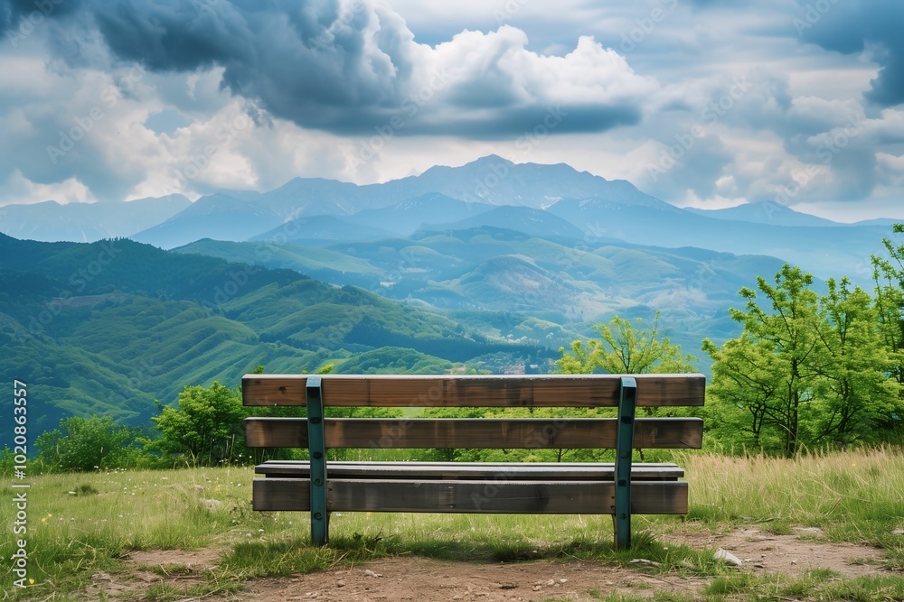 A wooden bench facing a vast, green mountain range under dramatic clouds, symbolizing a peaceful and serene view of nature. A wooden bench facing a vast, green mountain range under dramatic clouds, symbolizing a peaceful and serene view of nature.