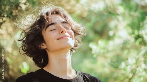 Serene Young Man Enjoying Nature with Sun-kissed Hair