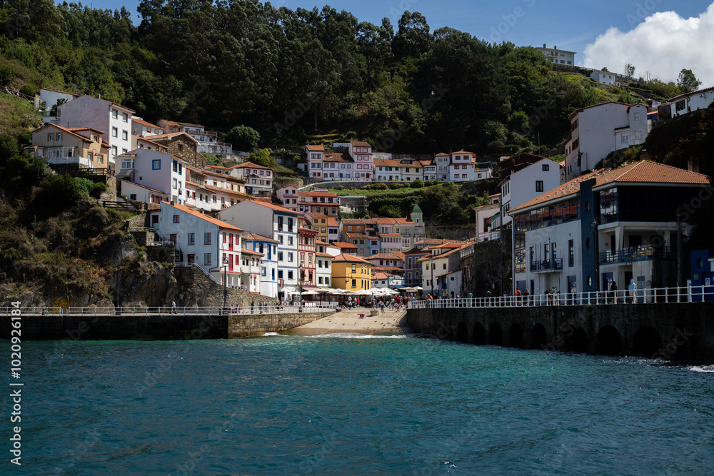 A picturesque coastal village nestled on a hillside, with colorful houses cascading down to the waterfront. The crystal-clear water reflects the vibrant buildings, creating a stunning scene.
A picturesque coastal village nestled on a hillside, with colorful houses cascading down to the waterfront. The crystal-clear water reflects the vibrant buildings, creating a stunning scene.