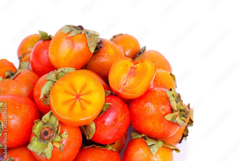 Heap of persimmon fruits isolated on white background. Copy space for text. Heap of persimmon fruits isolated on white background. Copy space for text.