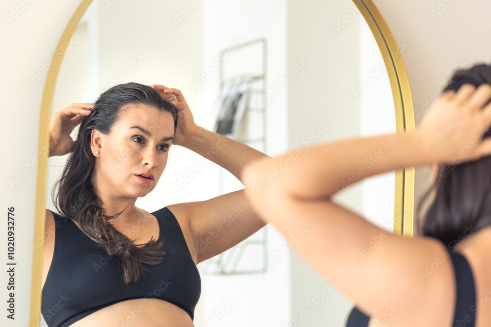 Pregnant woman near the mirror.Pregnancy and style concept. Pregnant woman near the mirror.Pregnancy and style concept.