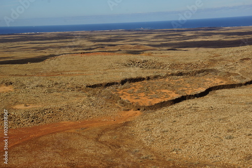 desertic landscape of volcano and caldera on the sea side