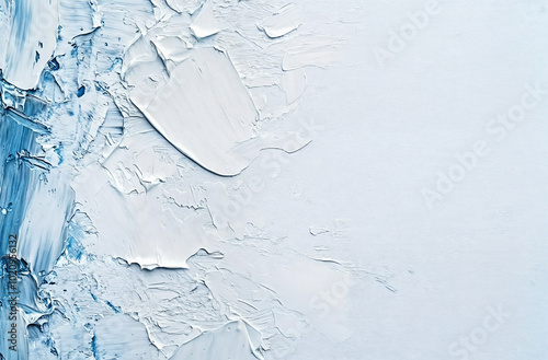 Painting background of textured white and blue oil paint with visible brush strokes and uneven patterns on the surface. photo