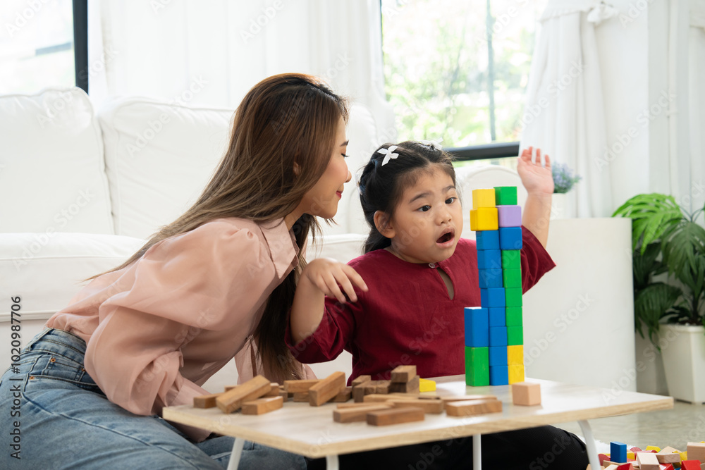 Cherry young mother plays colorful toy block with her Down syndrome daughter, colorful wooden toys can increase skills and learning to increase the development, special education, Knowing slowly Cherry young mother plays colorful toy block with her Down syndrome daughter, colorful wooden toys can increase skills and learning to increase the development, special education, Knowing slowly