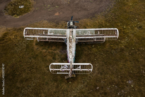 Old abandoned small airplane in the field