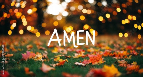 amen lettering on autumn nature concept blurred lights bokeh background photo