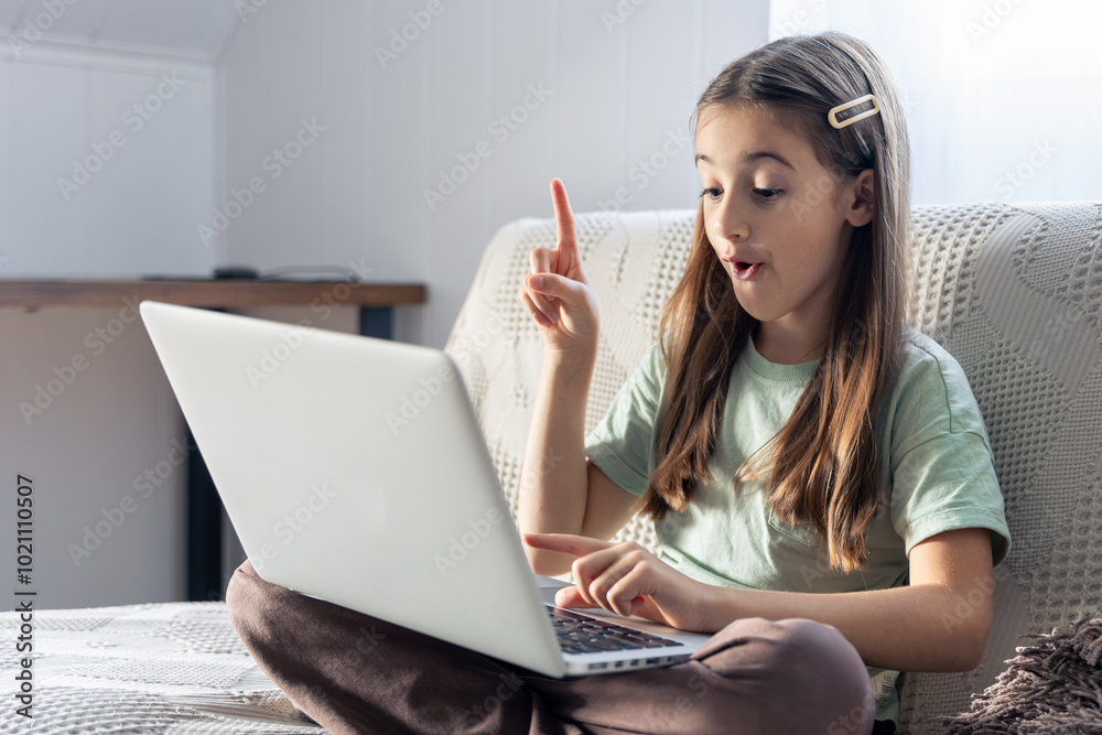 A schoolgirl studies online at home. School education online. A schoolgirl studies online at home. School education online.