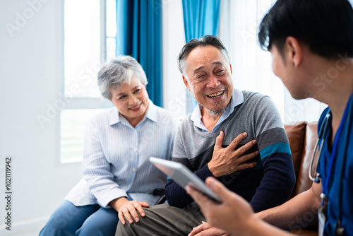 asian senior man consult and discuss his medical examination results with caregiver at premium clinic, elderly retirement people get nursing home care wellness service for healthy lifestyle photo