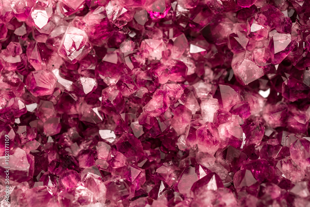 Amethyst garnet crystals. Burgundy gemstone. Mineral crystals in the natural environment. Texture of precious and semiprecious stones. Colored shiny surface of precious stones. Amethyst garnet crystals. Burgundy gemstone. Mineral crystals in the natural environment. Texture of precious and semiprecious stones. Colored shiny surface of precious stones.