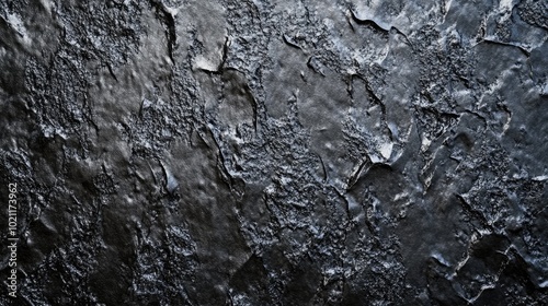 Textured black surface with a rugged finish, perfect for artistic backgrounds.