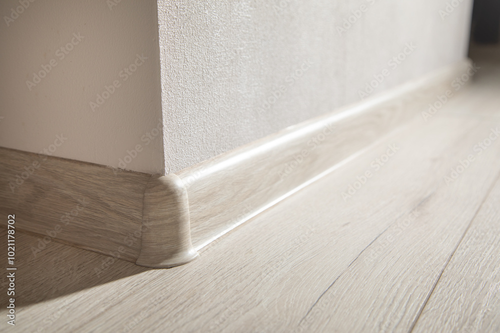 Decorative baseboard corner in empty room.