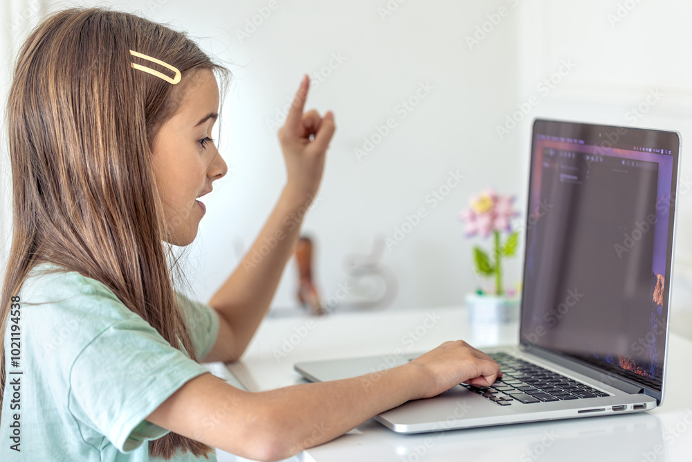 A schoolgirl studies online at home. School education online. A schoolgirl studies online at home. School education online.