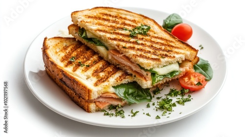 A grilled sandwich with spinach, cheese, and tomatoes on a plate, ready to be enjoyed.