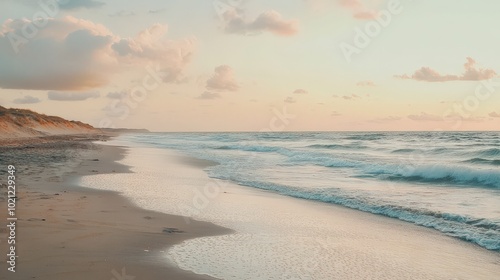 Serene beach at sunset with soft waves and a pastel sky, creating a peaceful atmosphere.