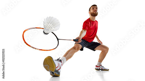 Badminton player lunges forward to intercept fast shuttlecock. Moment of athletic precision and quick reflexes on court. Concept of professional sport, event, precision, athlete, speed and action photo