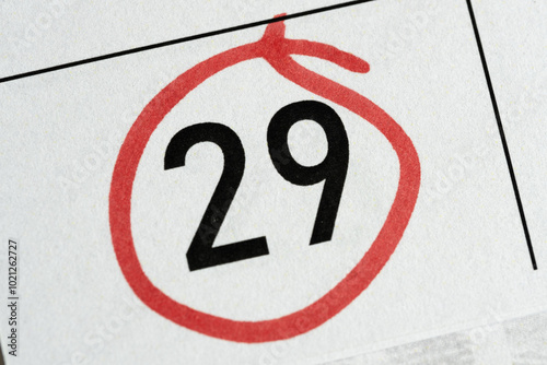 Twenty ninth number in calendar is circled with red marker. photo