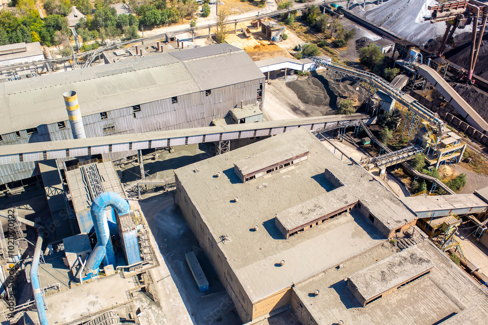 Cement plant view from above. Workshops and compressors, equipment, metallurgy. Technological work on cement production. Industrial production on a large scale. Cement plant view from above. Workshops and compressors, equipment, metallurgy. Technological work on cement production. Industrial production on a large scale.