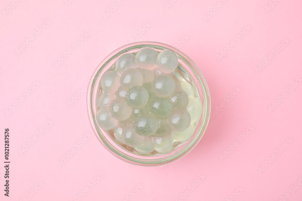Tapioca pearls in bowl on pink background, top view Tapioca pearls in bowl on pink background, top view