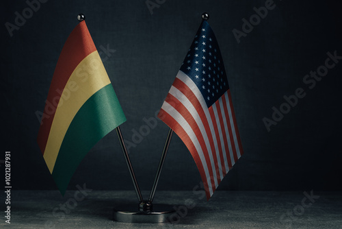 Фотография Table flags United States America and National Flag Bolivia on dark background