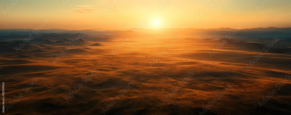 Aerial View of a Vast, Golden Desert Landscape at Sunset Aerial View of a Vast, Golden Desert Landscape at Sunset