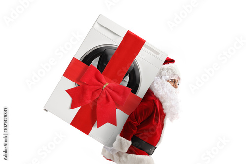 Santa claus carrying a wrapped washing machine with a ribbon on his back photo