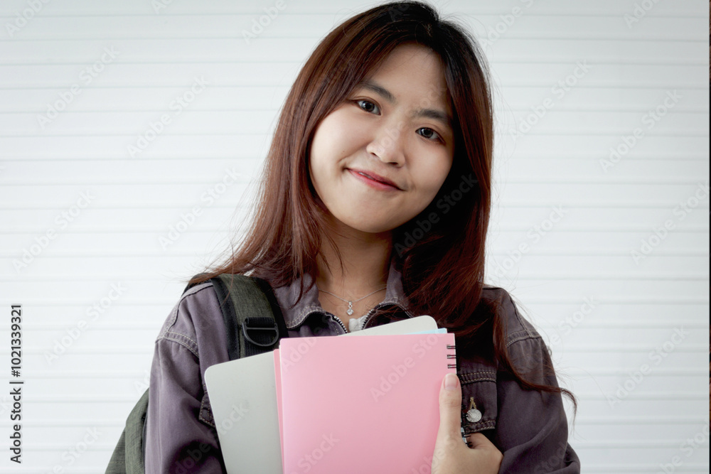 Portrait of Asian high school girl student holding book, standing in classes. Female student engages in study. Happy college pupil spending time learning. University kid with senior education. Portrait of Asian high school girl student holding book, standing in classes. Female student engages in study. Happy college pupil spending time learning. University kid with senior education.
