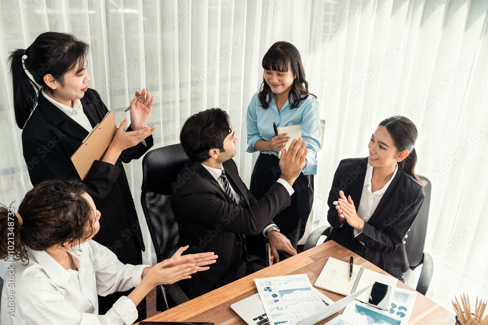 Group of happy businesspeople in celebratory gesture and successful efficient teamwork. Diverse race office worker celebrate after made progress on marketing planning in corporate office. Meticulous Group of happy businesspeople in celebratory gesture and successful efficient teamwork. Diverse race office worker celebrate after made progress on marketing planning in corporate office. Meticulous